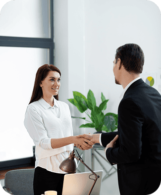 Professional business handshake in office setting.